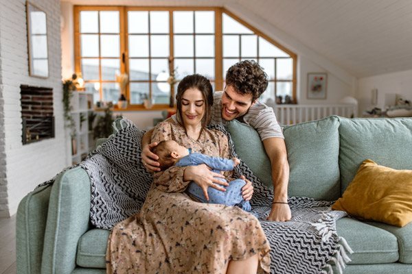 a mother and father admiring their baby