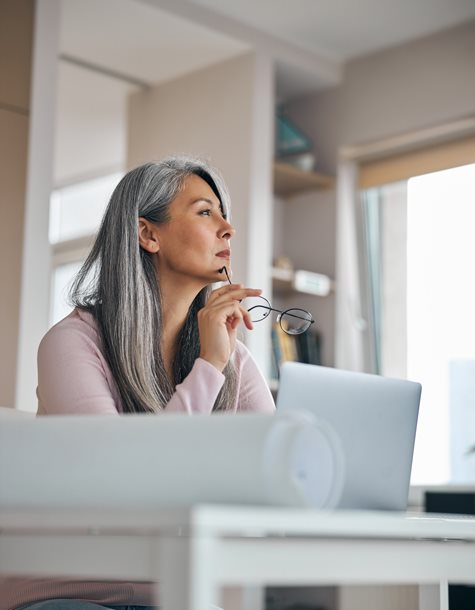 woman thinking infront of her laptop